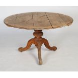 A 20th century beech tilt-top breakfast table, the base with three scrolling legs (damages).
