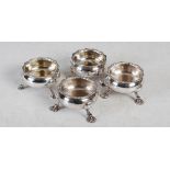 Two pairs of mid 18th century English silver table salts, all with fluted rims on three scalloped