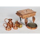 Group of copper items, including a set of three copper measuring jugs of flagon form, a pair of
