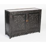 A Chinese carved darkwood cabinet, Qing Dynasty, the double cupboard doors carved with two panels of