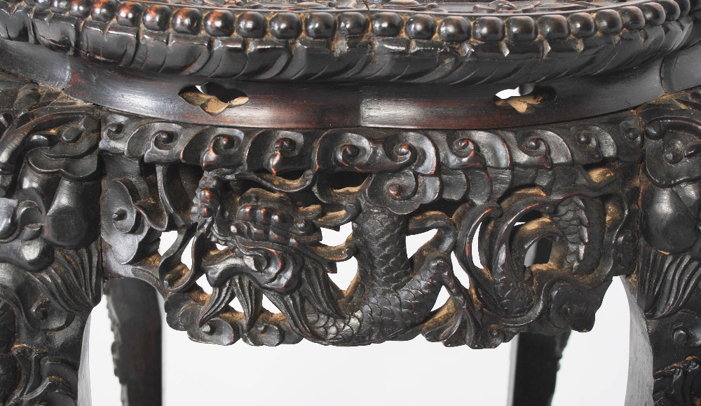 A Chinese carved darkwood stand, Qing Dynasty, the round top carved with a frieze of auspicious - Image 6 of 7