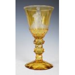 A 19th century Bohemian yellow tinted clear glass goblet, the bowl decorated with intaglio wheel-cut