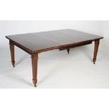 A 20th century mahogany extending dining table, of rectangular form with chamfered corners, with two