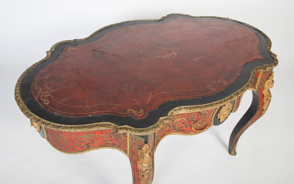 A 19th century ebonised and gilt metal mounted boulle centre table. The shaped oval top with gilt - Image 2 of 9