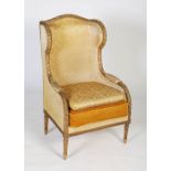 A 20th century gilt wood upholstered wing back armchair, in Louis XVI style, upholstered damask
