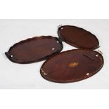Three early 20th century mahogany serving trays, all with twin handles and fluted gallery rims,
