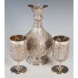 An Edwardian silver wine jug and pair of goblets, maker Dobson & Sons, London 1903/4, elaborately