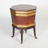 A George III mahogany octagonal brass bound wine cooler/ cellarette, twin brass carrying handles, on