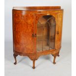 Early 20th century burr walnut demilune sideboard, a central astragal glazed door flanked by two