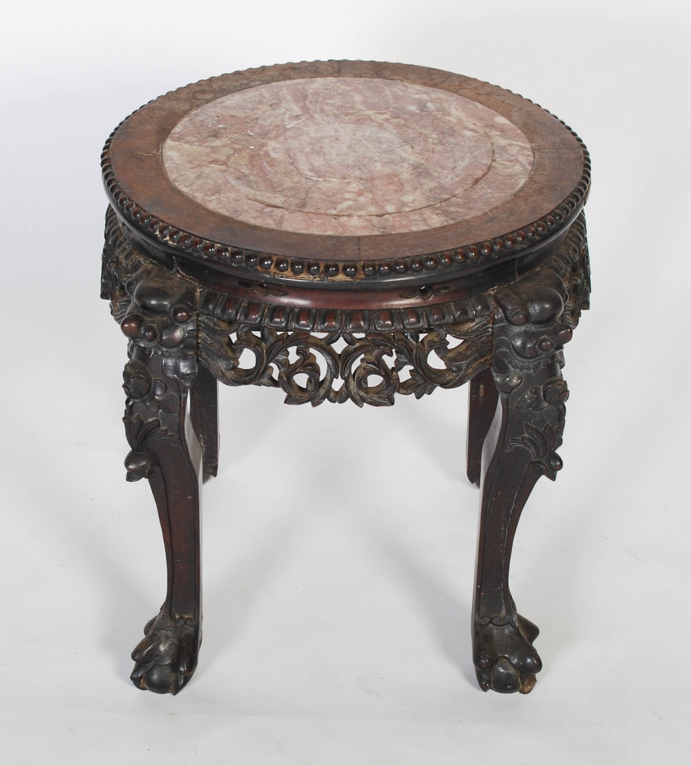 A Chinese carved darkwood stand, Qing Dynasty, the round top inset with marble, over carved and - Image 4 of 4