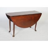 A George II mahogany dining table, circa 1740-60, the oval drop leaf top on four cabriole legs