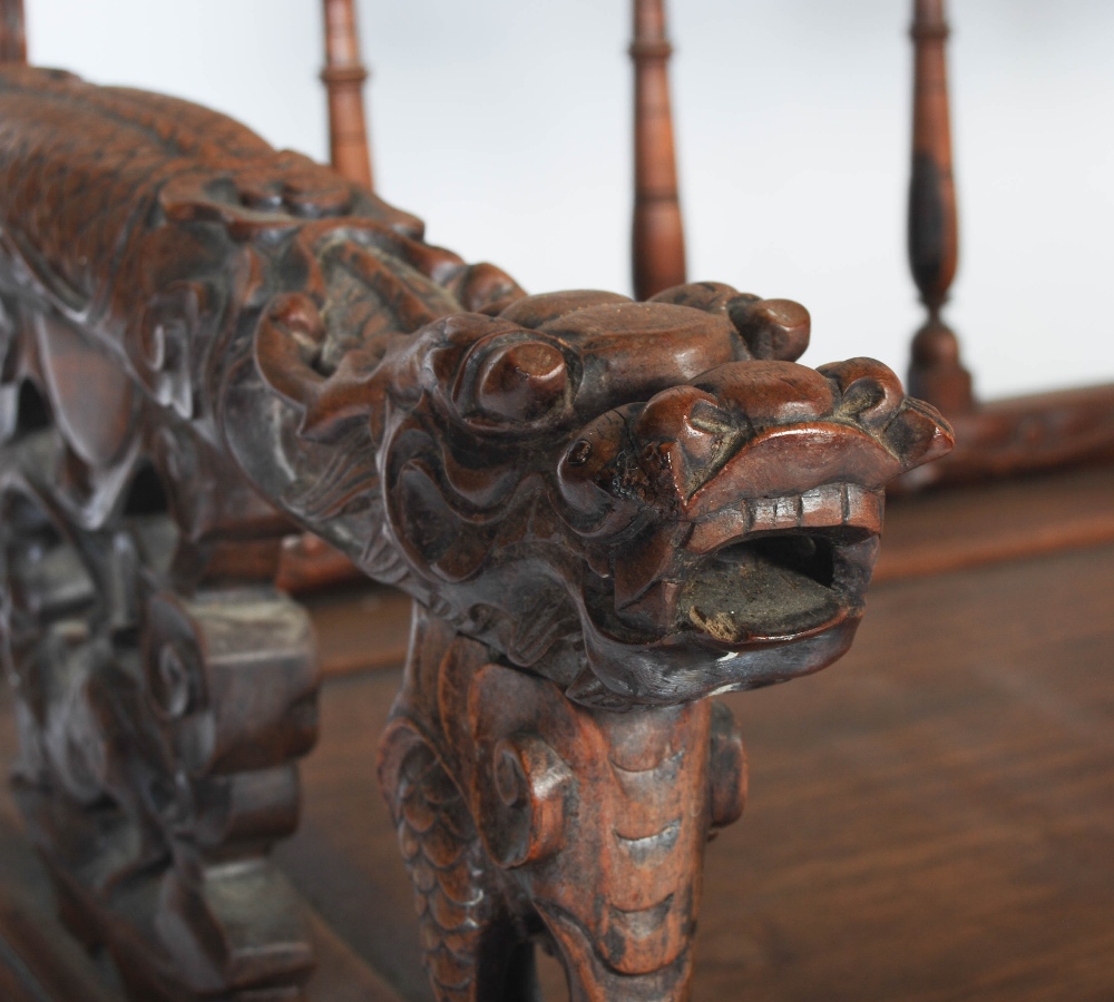 A Chinese carved darkwood bench, Qing Dynasty, the back richly carved in relief with two dragons - Image 3 of 8