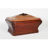 A 19th century mahogany cellarette, of very large sarcophagus form, the domed hinged top with carved
