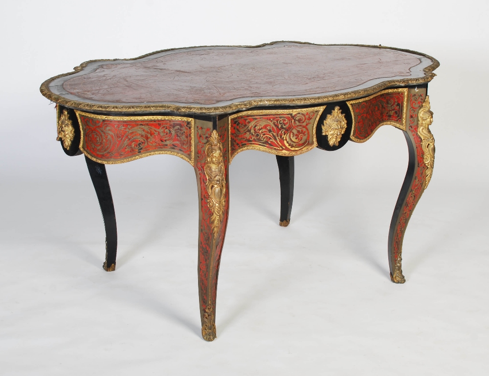 A 19th century ebonised and gilt metal mounted boulle centre table. The shaped oval top with gilt