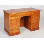 An early 20th century stained beech pedestal desk, with four drawers to each pedestal and a