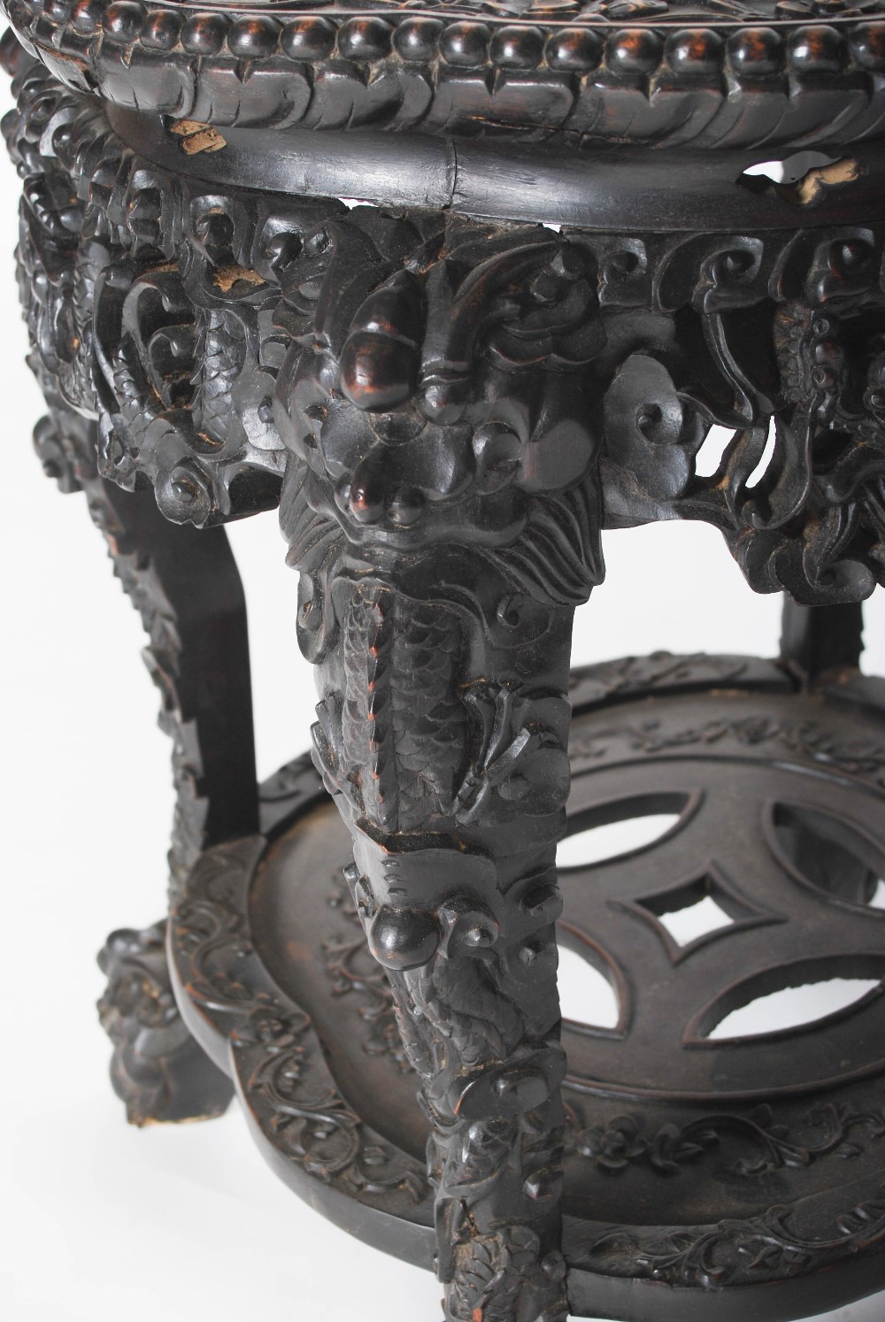 A Chinese carved darkwood stand, Qing Dynasty, the round top carved with a frieze of auspicious - Image 3 of 7