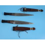 Pair of knives with leather handles in leather sheaths