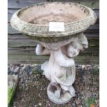 Stone cherub bird bath