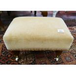 Small footstool on casters