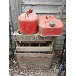 2 wooden advertising crates with 2 petrol cans