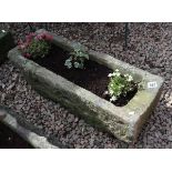 Stone trough planter with plants