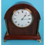 An Edwardian domed mahogany cased mantel time piece, in good working order with gilt pillars, set on