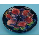 Moorcroft pin dish decorated with tube lined flower on blue background - Approx diameter12cm