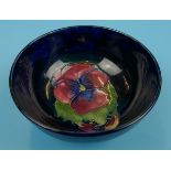 Moorcroft bowl decorated with tube lined flower on blue background - Approx diameter 11cm