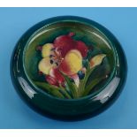 Moorcroft dish - decorated with tube lined flower on green background