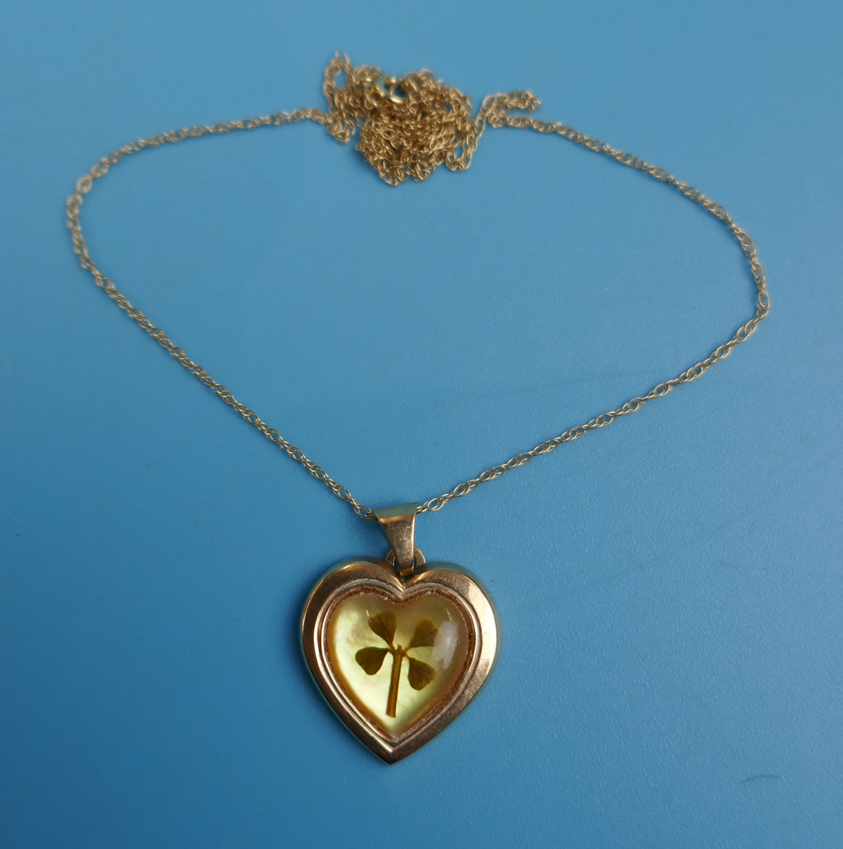 Gold heart pendant on gold chain