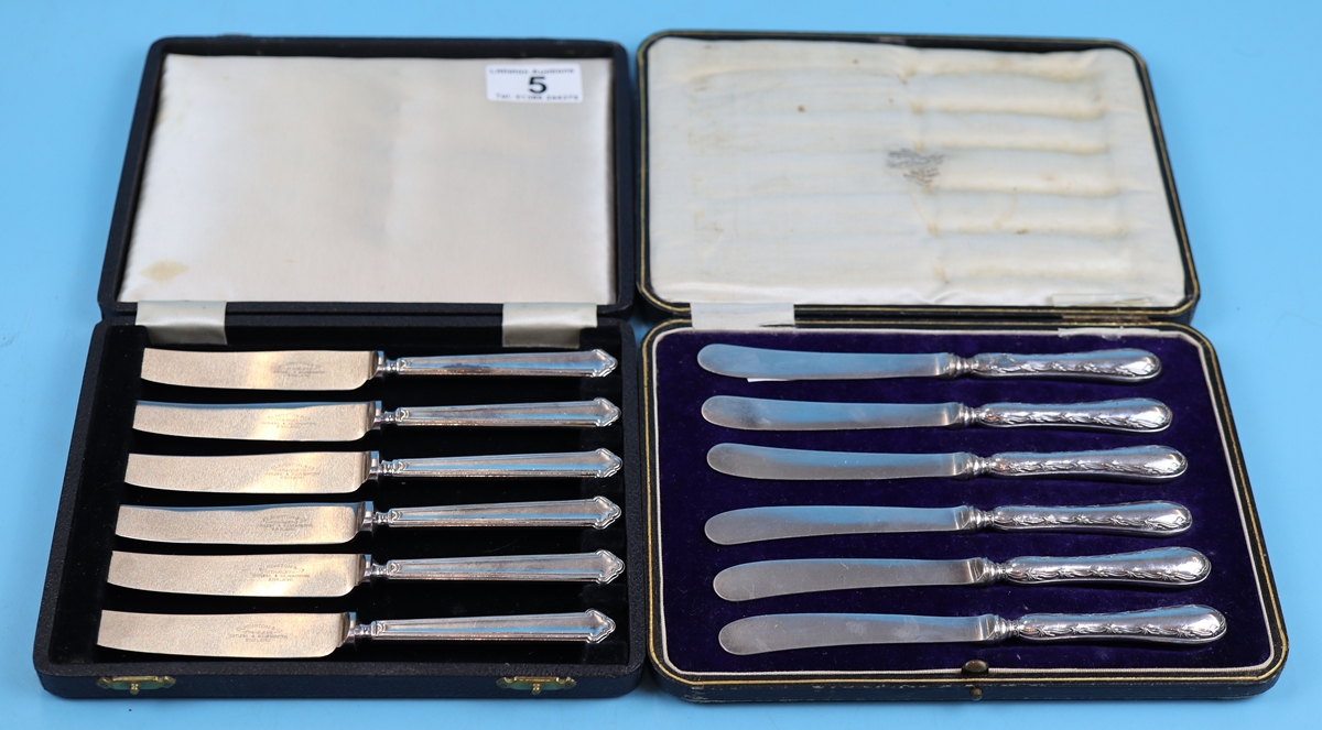 2 cased sets of butter knives, 1 with hallmarked silver handles