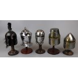 Collection of miniature reproduction helmets on stands