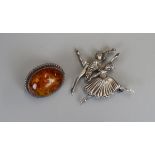 2 silver brooches, 1 being amber