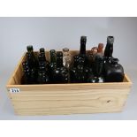 Collection of early bottles in wine crate