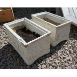 Pair of stone trough planters depicting cherubs