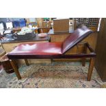 Oxblood red leather massage table with stirrups