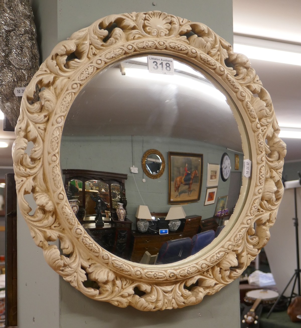 Convex mirror in ornate frame