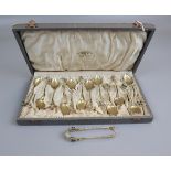 Cased collection of gilt plique de jour teaspoons and sugar nips to include some marked .925