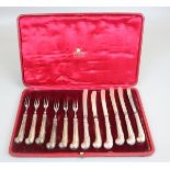 Cased set of pistol handled knives & forks with hallmarked silver handles