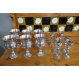 Set of six white metal goblets together with set of six white metal candle sticks