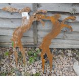 Pair of rusty silhouette boxing hares