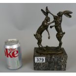 Bronze on marble base, boxing hares