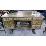 Oak desk with drawers to front & cupboards to rear - Approx size W: 140cm D: 70cm H: 76cm