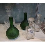 3 decanters and 2 green bottles