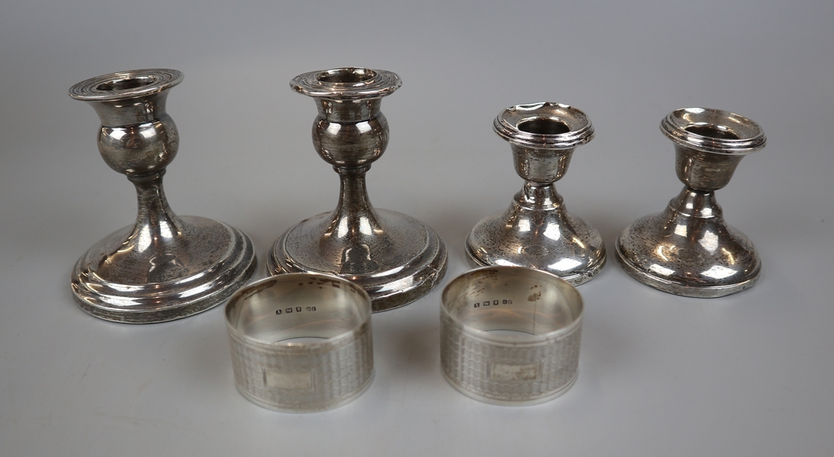 4 hallmarked silver candlesticks & 2 hallmarked silver napkin rings