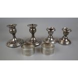 4 hallmarked silver candlesticks & 2 hallmarked silver napkin rings