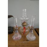 3 small oil lamps to include a pair