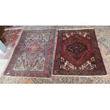 2 red patterned rugs