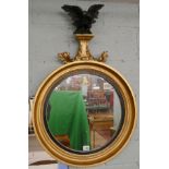 Round gilt framed mirror adorned with eagle