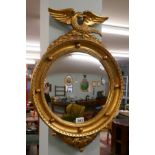 Gilt framed convex mirror adorned with eagle